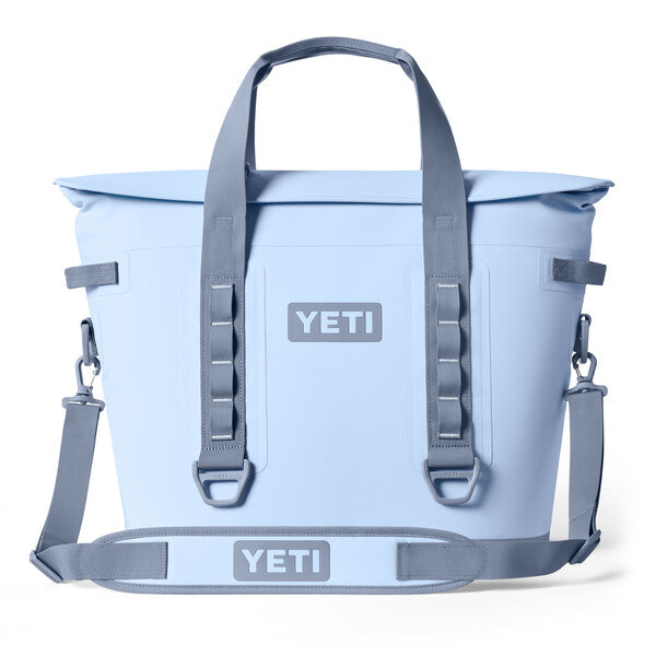 A blue sale YETI Hopper M30 soft cooler with shoulder straps and handles.
